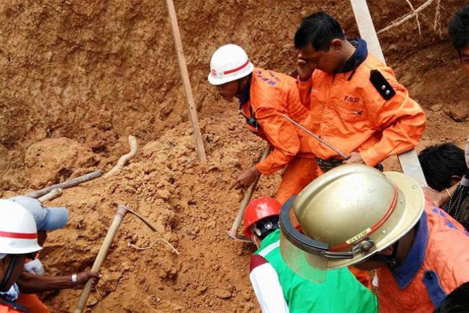 Rescue workers digging at a landslide at a monastery in Mayangon Township on 24 January. Photo: Myanmar fire brigade

