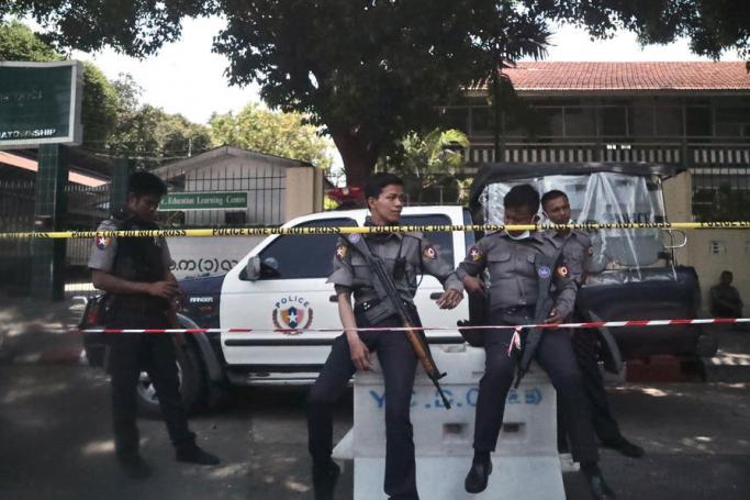 Police officers stand guard outside a high school in Yangon, Myanmar, 01 June 2021. Photo: EPA