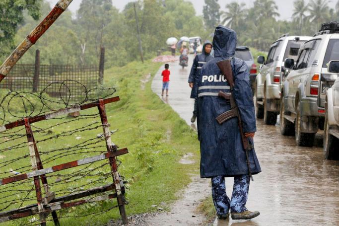 Police stand near the checkpoint at the Shwe Zar village in Maungdaw township, Rakhine State, western Myanmar. Photo: Nyein Chan Naing/EPA