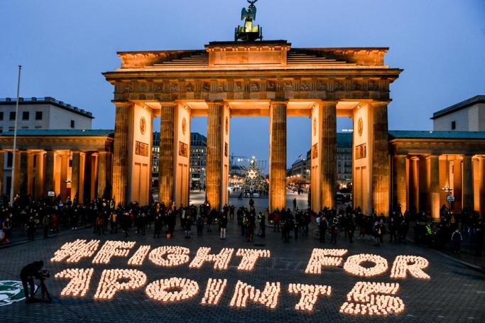 Fridays For Future activists create slogan made by candles #fight for 1 point 5´ on occasion of the fifth anniversary of the signing of the Paris Climate Agreement, in front of the the Brandenburg Gate in Berlin, Germany, 11 December 2020. Photo: EPA