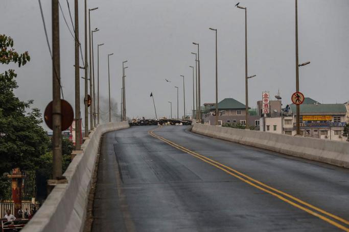 A view of a road blocked by protesters and resident near BayintNaung bridge which link to Hlaingthaya (Hlaing Tharyar) Township, outskirts of Yangon, Myanmar, 14 March 2021. Photo: EPA