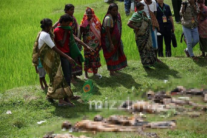 Relatives of Hindu victims look near the dug corpses outside Yebawkya village of Maungdaw township in Rakhine State on 27 September 2017. Photo: Thura/Mizzima
