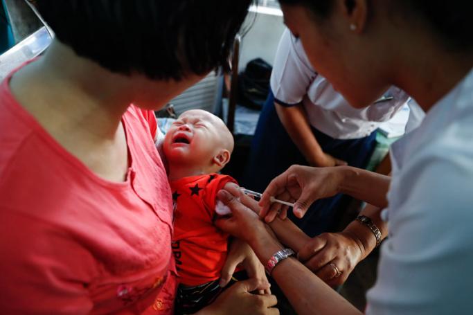 A nurse from township public health department injects measles and rubella vaccine to a child during a regular vaccinating session in Yangon, Myanmar, 14 February 2019. Photo: Lynn Bo Bo/EPA