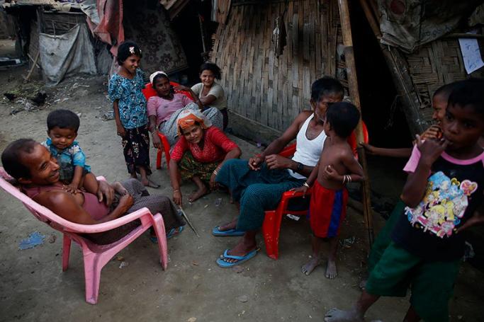 Members of a Rohingya family sit in front of their shelter at Thet Kel Pyin internally displaced person (IDPs) camp near Sittwe of Rakhine State, western Myanmar, 07 March 2017. Photo: Lynn Bo Bo/EPA
