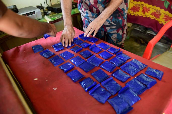 This photograph taken on April 6, 2018 shows a Bangladesh Border Guard (BGB) laying out small bags of the drug "yaba" recovered from a passenger bus in a search at a checkpost along the Teknaf-Cox's Bazar highway in Teknaf. Photo: Munir Uz Zaman/AFP
