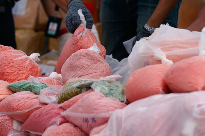 (File) A Thai Food and Drug Administration (FDA) official prepares bags with methamphetamine pills, as part of the 9,321 kg of illegal drugs to be burned in a high-power oven, during the 47th destruction of confiscated narcotics ceremony at Bang Pa-in Industrial Estate in Ayutthaya province, Thailand, 26 June 2017. Photo: Narong Sangnak/EPA
