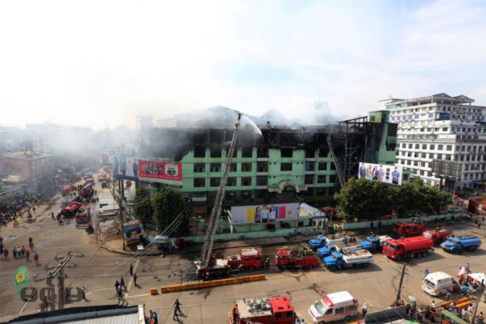 Firefighters extinguish a fire at Mingalar market, Yangon's largest wholesale and retail market, in Yangon on 9 January, 2016. Photo: Thet Ko/Mizzima
