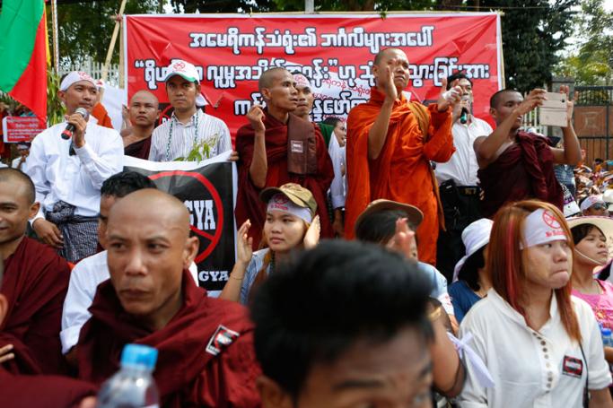 Buddhist monks and nationalists hold placards in front of the US embassy during an unauthorised demonstration against the use of the term 'Rohingyas' in Yangon, Myanmar, 28 April 2016. Photo: Lynn Bo Bo/EPA
