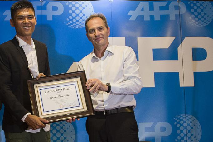 Myanmar journalist Mratt Kyaw Thu (L) receives the AFP Kate Webb prize award from Philippe Massonnet (R), Agence France-Presse Asia Pacific Regional Director during the award ceremony at the French Institute in Yangon on February 5, 2018. Photo: Ye Aung Thu/AFP
