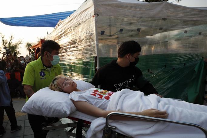 Tantawan Tuatulanon, a Thai activist charged with royal defamation, lies on a stretcher as she arrives after leaving hospital to continue a hunger strike outside the Supreme Court in Bangkok, Thailand, 24 February 2023. Photo: EPA