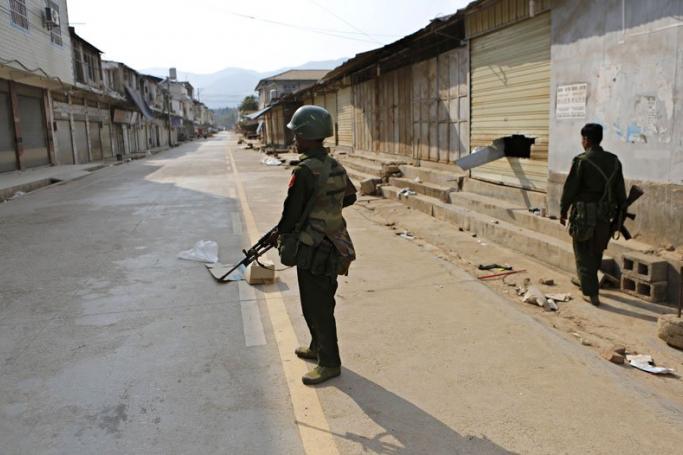 Armed military soldiers stand guard on a deserted street in self-administered Kokang capital Laukkai, northern Shan State, Myanmar, 16 February 2015. Photo: Lynn Bo Bo/EPA
