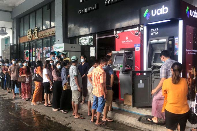 People wait near ATM machines to withdraw the cash in Yangon, Myanmar, 29 April 2021. Photo: EPA