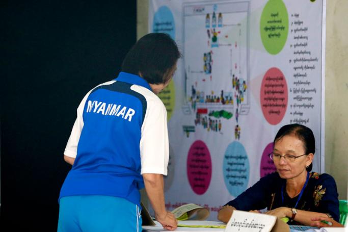 A woman registers to vote at a polling station of Tarmwe township during by-elections in Yangon, Myanmar, 03 November 2018. Photo: Nyein Chan Naing/EPA