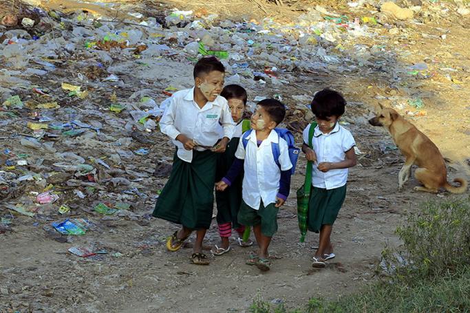 Myanmar children go to school near the bank of the Irrawaddy River in Mandalay, Myanmar. Photo: Hein Htet/EPA
