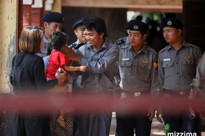 Detained Reuters journalist Kyaw Soe Oo (R) meets with his daughter accompany by his wife, as he arrives to the court in Yangon on 01 February 2018. Photo: Thet Ko/Mizzima
