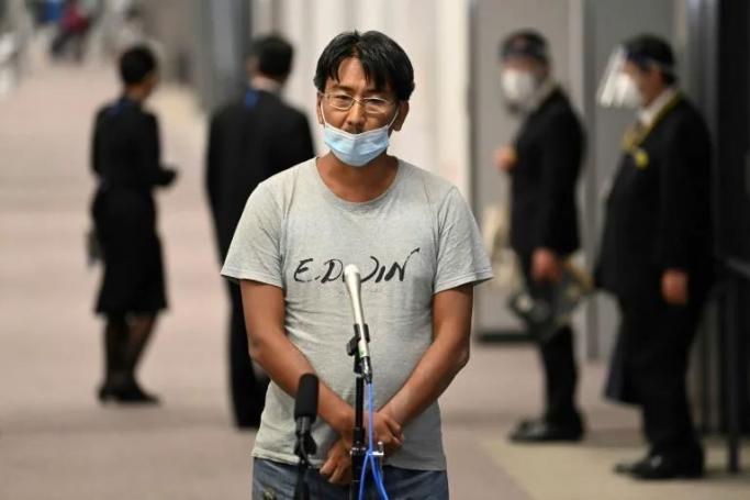 Japanese journalist Yuki Kitazumi, who was arrested by security forces while covering the aftermath of the Myanmar coup, speaks to the media upon his arrival at Narita Airport in Narita, Chiba prefecture on May 14, 2021, after charges against him were dropped as a diplomatic gesture. Photo: AFP