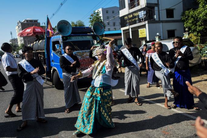 A dancer performs in front of a truck loaded with large speakers playing loud traditional music during Buddhist religious festivities in Yangon on November 22, 2018. Photo: Ye Aung Thu/AFP