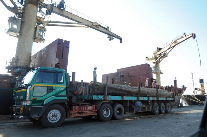 A truck waits to unload wooden logs onto a ship at the Myanmar International Terminals at the huge Thilawa industrial zone project near Yangon. Photo: AFP
