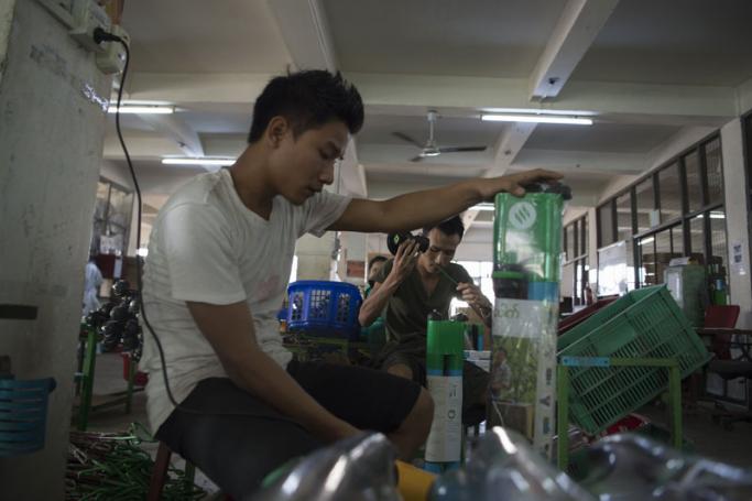 Labourers working in a 3D printing factory in Yangon. Photo: Ye Aung Thu/AFP
