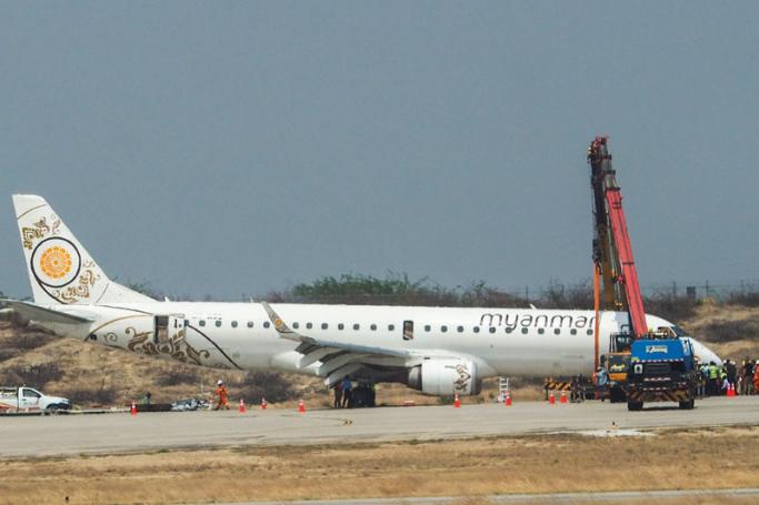 Emergency services at the site where a Myanmar National Airlines plane made an emergency landing, at the Mandalay International Airport, Mandalay, Myanmar, 12 May 2019. Photo: EPA