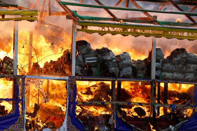 Illegal drugs burn during a destruction ceremony held to mark the International Day Against Drug Abuse and Illicit Trafficking in Yangon, Myanmar. Photo: EPA