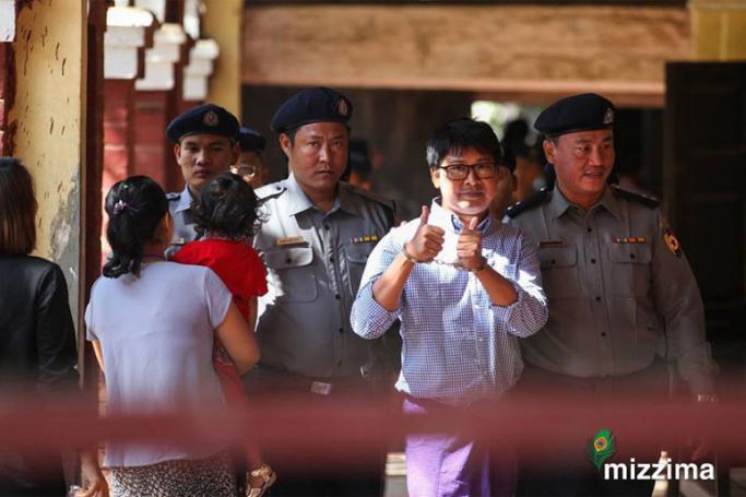 Myanmar police officers escort Reuters journalist Wa Lone (C) as he arrives at the northern district court in Yangon on 1 February 2018. Photo: Thura/Mizzima
