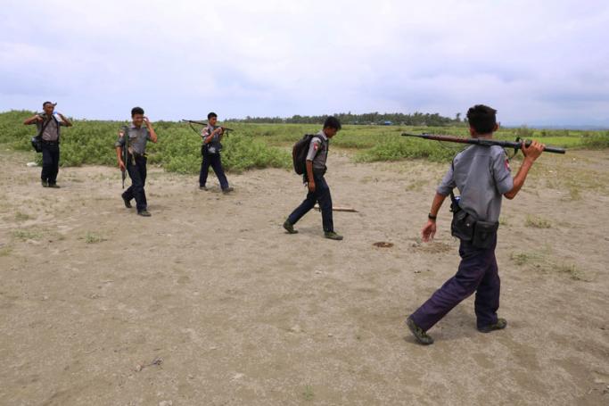 In this photo taken on September 7, 2017, armed Myanmar police patrol fields in northern Maungdaw in the Rakhine state in northern Myanmar. Photo: AFP
