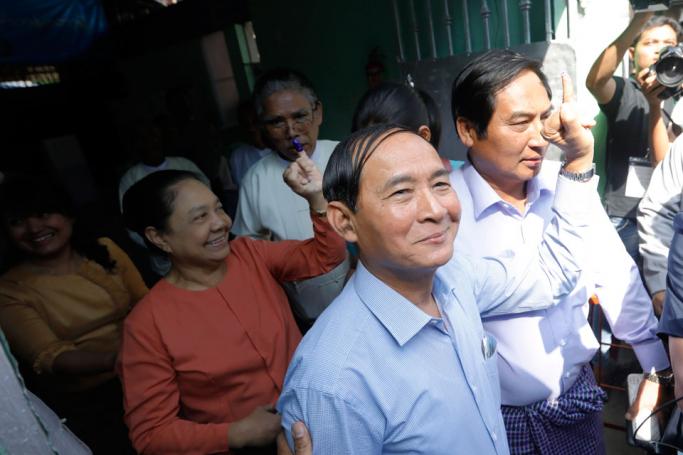 (File) Myanmar president Win Myint (C, front) and his wife Cho Cho (L) show their ink-marked fingers after voting at a polling station of Tarmwe township during by-elections in Yangon, Myanmar, 03 November 2018. Photo: Nyein Chan Naing/EPA