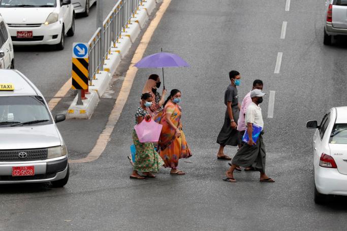 Pedestrians in protective masks cross a road in downtown Yangon, Myanmar, 18 May 2020. Photo: Nyein Chan Naing/EPA