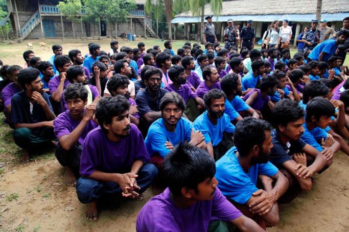 Rohingya Muslims from Bangladesh rescued by the Myanmar navy sit together at a temorary refugee camp in the village of Aletankyaw in the Maungdaw township of northern Rakhine state, Myanmar, 23 May 2015. Photo: Nyunt Win/EPA

