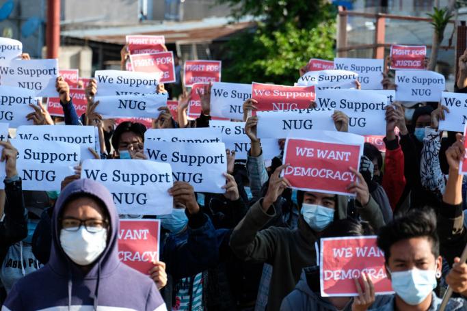 Protesters hold posters in support of the National Unity Government (NUG) during a demonstration against the military coup on "Global Myanmar Spring Revolution Day" in Taunggyi, Shan state on May 2, 2021. Photo: AFP