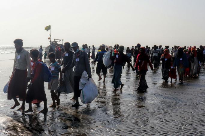 Rohingya people who were arrested at sea in December walk on a beach after being transported by Myanmar authorities to Thalchaung near Sittwe in Rakhine state on January 13, 2020. Photo: AFP