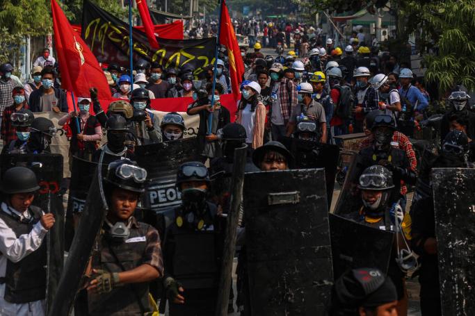 Demonstrators display placards and shout slogans during a protest against the military coup, in Mandalay, Myanmar, 13 March 2021. Photo: EPA