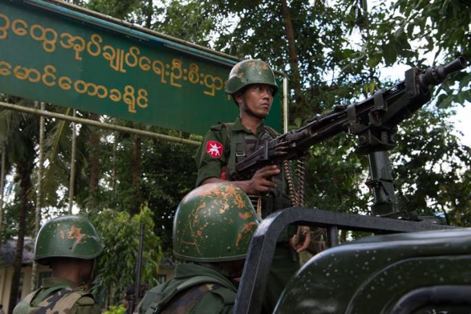 In this picture taken on September 27, 2017, Myanmar soldiers stand guard in Maungdaw in Myanmar's northern Rakhine state. Photo: AFP
