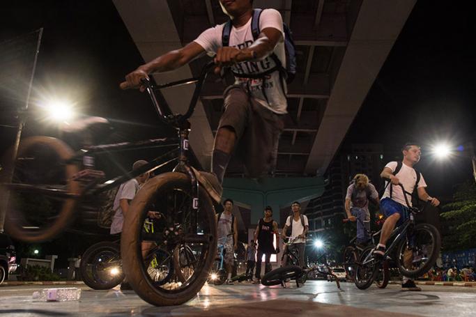 This photo taken on April 27, 2017 shows young Myanmar performing stunts under a bridge in downtown Yangon. Skidding and screeching across the concrete the young bikers perform a carefully choreographed dance of gravity-defying stunts, a dazzling display of Myanmar's thriving youth culture on the streets of its biggest city. Photo: Ye Aung Thu/AFP
