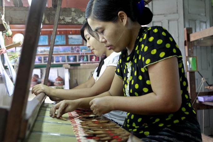 Workers arrange the pattern for Chate Longyi on a loom at the Shwe Sin Tai Silk House in Amarapura, Mandalay, Myanmar. Photo: Pyae Sone Aung/EPA
