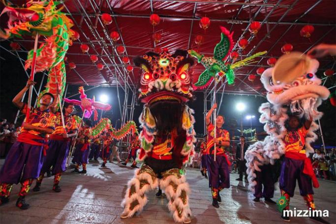 Dragon dancer of Moe Nagar Chinese Dragon and Hong Teck Myanmar Lion dance team control the dragon head as they perform in the streets of Chinatown during celebrations for the upcoming Chinese Lunar New Year or Spring Festival in Yangon on 06 February 2018. Photo: Thura/Mizzima
