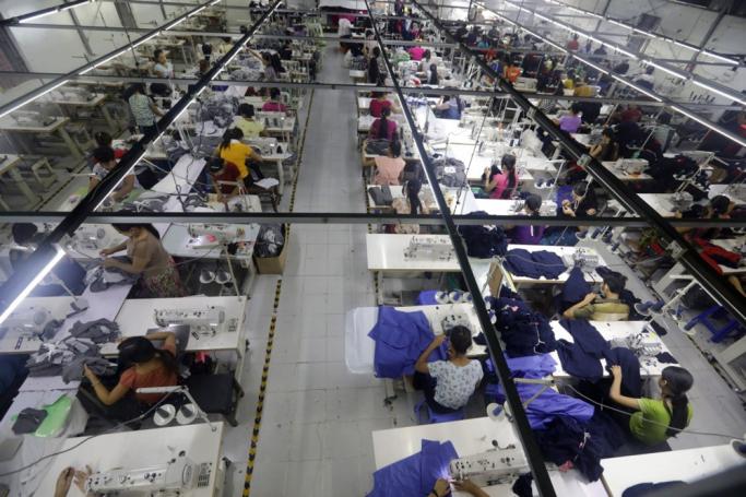 Employees work at a garment factory in Shwe Pyi Thar, Yangon, Myanmar. Photo: EPA