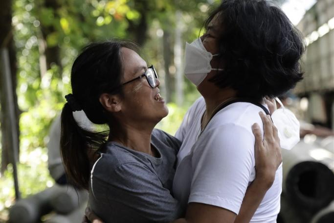 (File) Released detainee Tu Tu Tha (L), 49, a writer and journalist, greets with her friend outside Insein prison in Yangon, Myanmar, 19 October 2021. Photo: EPA