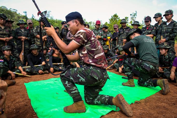 Members of the KNDF watching a demonstration on how to operate weapons during a training session for female special forces members and women battalions at their base camp in the forest near Demoso in Myanmar's eastern Kayah state. Photo: KNDF/AFP