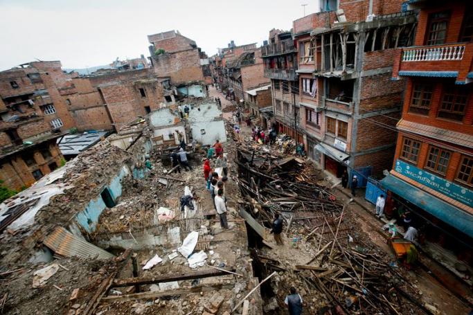 People look through the rubble trying to salvage as much as possible from their dilapidated houses destroyed in the 25 April earthquake in Bhaktapur, Kathmandu, Nepal, April 29, 2015. Photo: Diego Azubel/EPA
