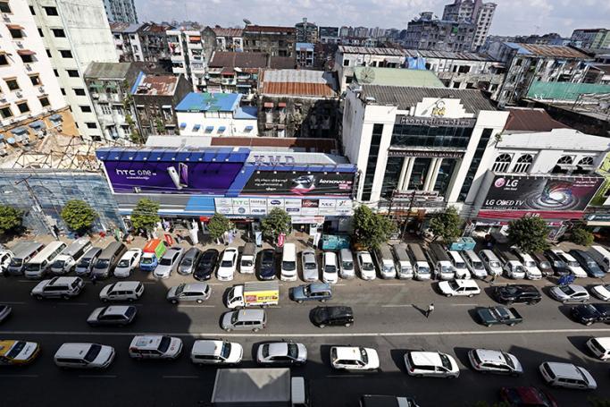 (File) Cars queue on the road in downtown Yangon. Photo: Nyein Chan Naing/EPA