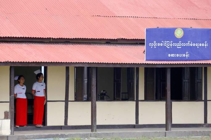 Nurses stand at the entrance of the clinic at Hla Phoe Khaung transit camp in Maungdaw township, Rakhine State. Photo: Nyein Chan Naing/EPA