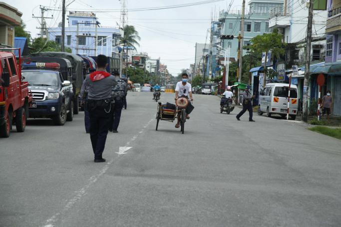 Myanmar police forces stand guard on the street as they patrol around the downtown area in Sittwe, Rakhine State, western Myanmar, 26 August 2020. Photo: Nyunt Win/EPA