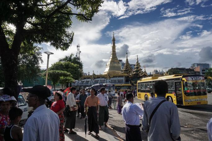 People walking in front of the Sulay Pagoda in downtown area of Yangon. Photo: Ye Aung Thu/AFP
