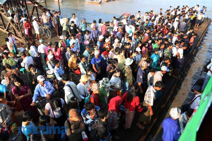 People wait for a ferry at the Dala Jetty in Yangon. Photo: Mizzima
