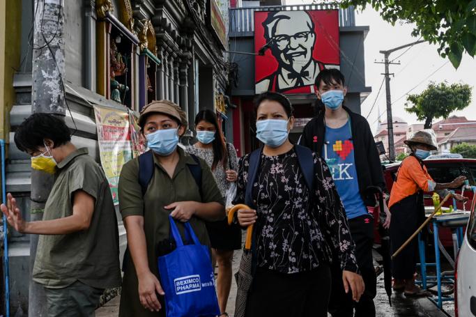 People walk in the downtown area of Yangon on June 10, 2020, as Myanmar's economy reopens following restrictions to halt the spread of the COVID-19 coronavirus. Photo: Ye Aung Thu/AFP