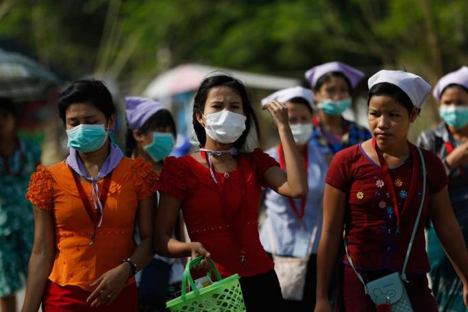 Myanmar workers wearing protective face masks. Photo: EPA