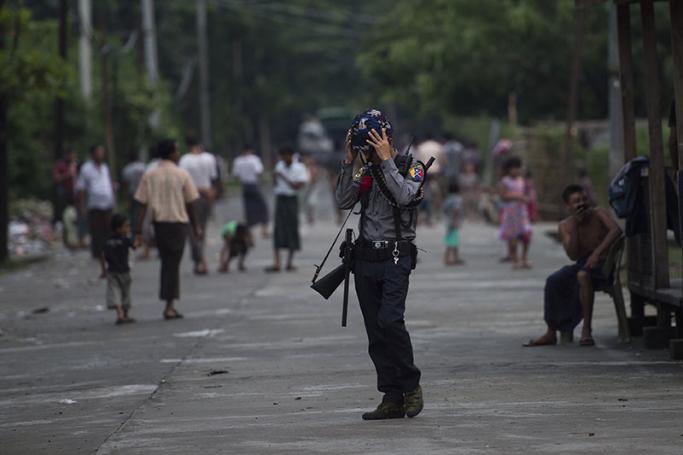 An armed Myanmar police officer stands guard in Aung Mingalar ward in Sittwe, the capital of Rakhine State. Photo: AFP
