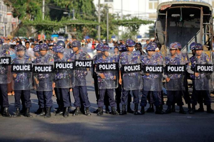 Policemen holding shields as they block the road in front of Yangon City Hall after a crackdown on a students' protest demanding an amendment to National Education Bill in Yangon, Myanmar, March 5, 2015. Photo: Lynn Bo Bo/EPA
